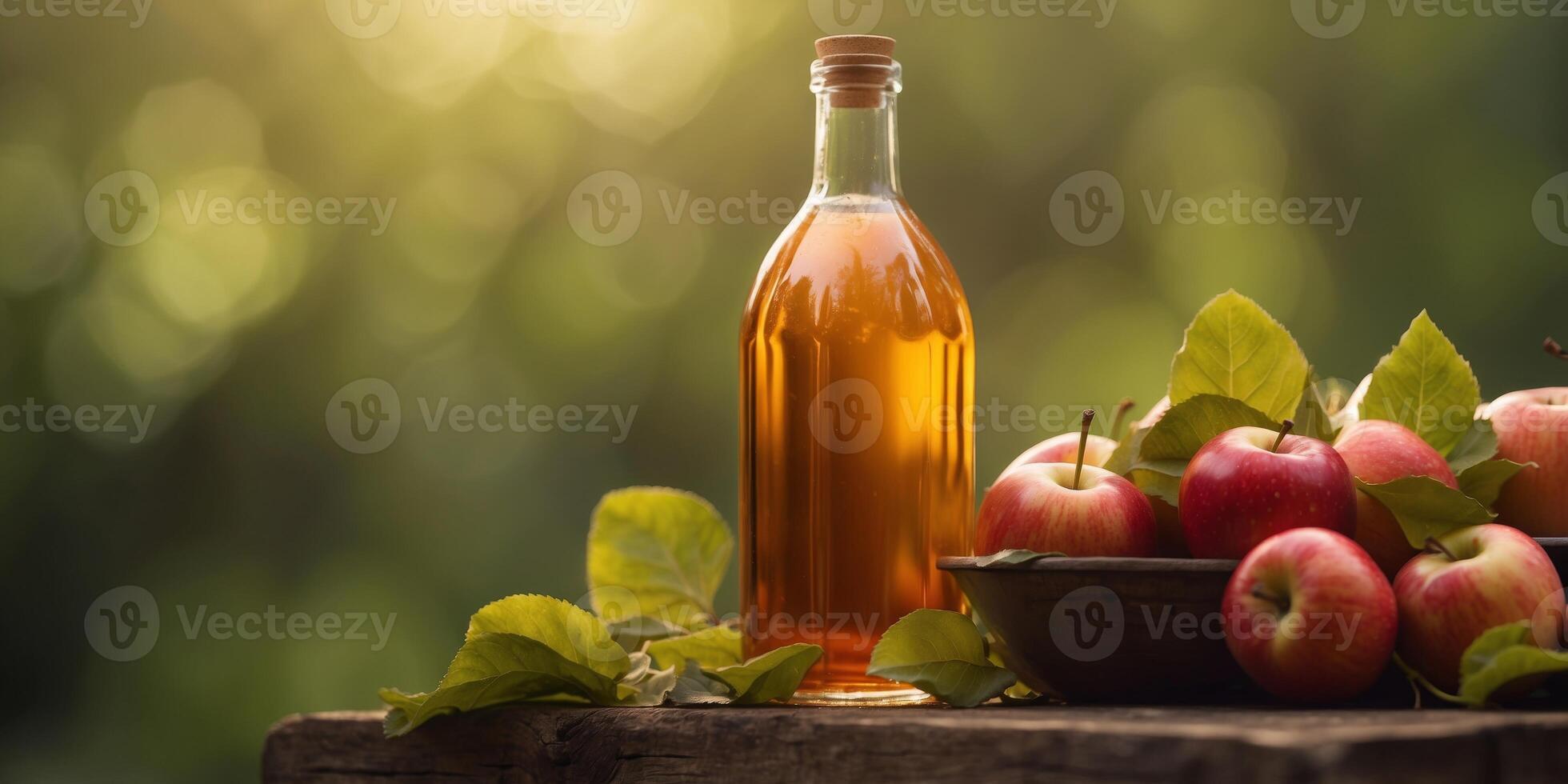 Apple cider vinegar bottle surrounded by fresh apples and leaves. photo