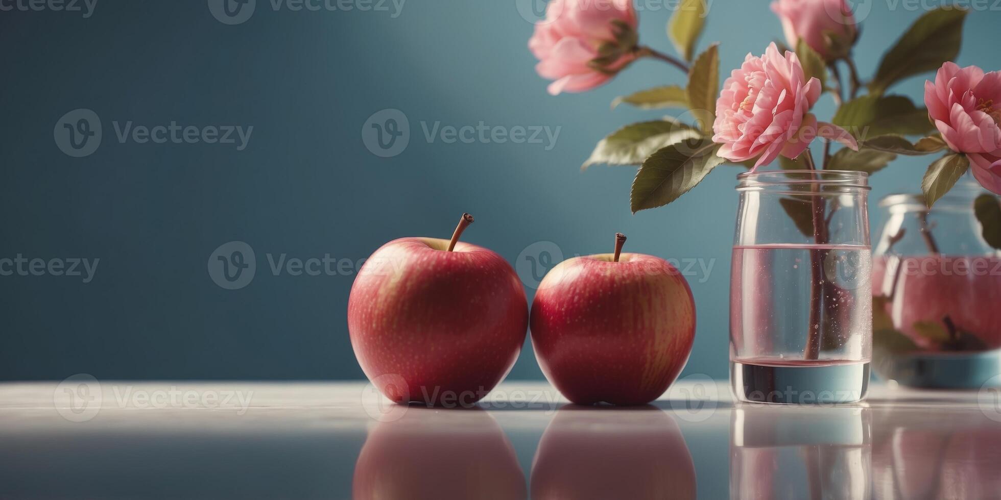 Two apples with one as water vessel holding pink bloom. photo