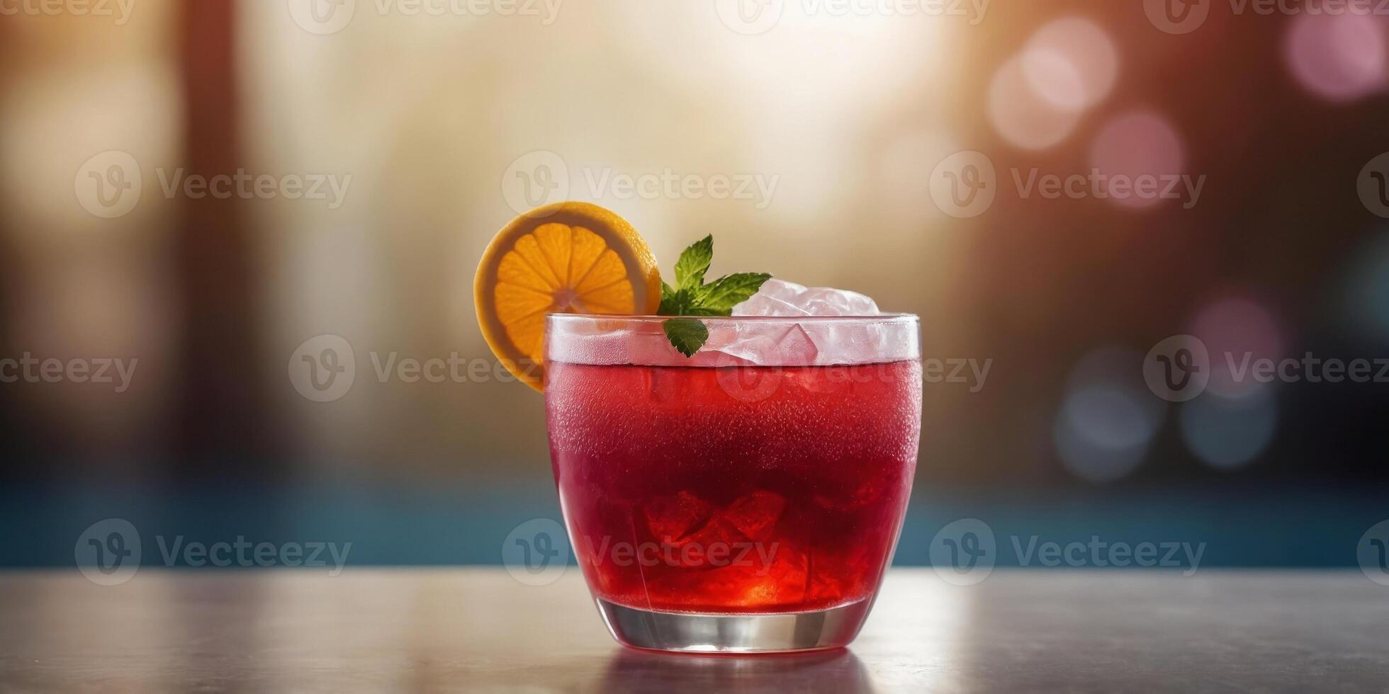 Frozen red beverage in clear cup on shiny table. photo