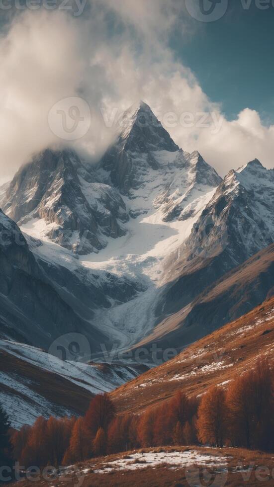 Alpine landscape with peaks covered by snow and clouds. photo
