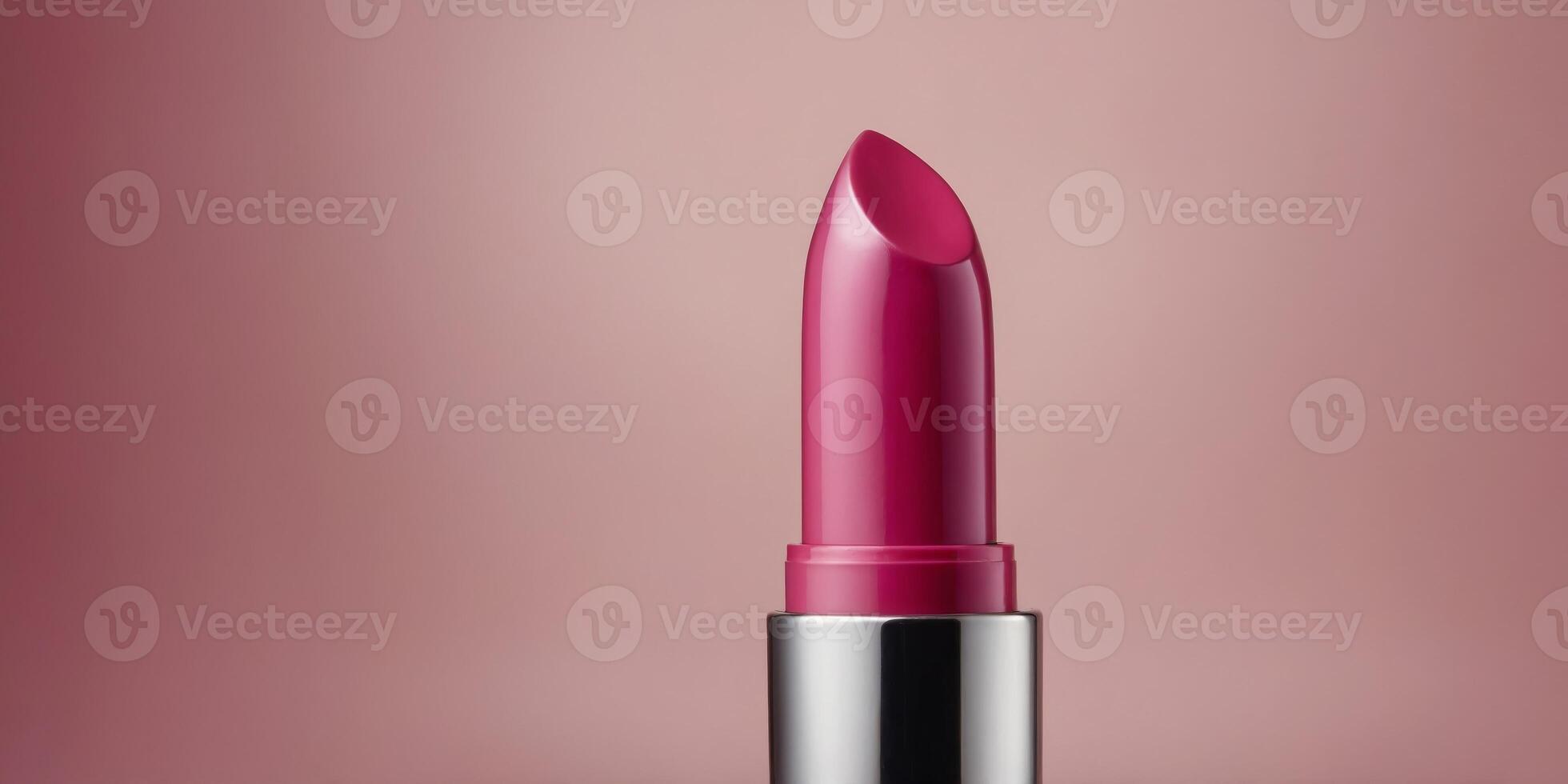 A pink tube of lipstick is shown with a pink background. photo
