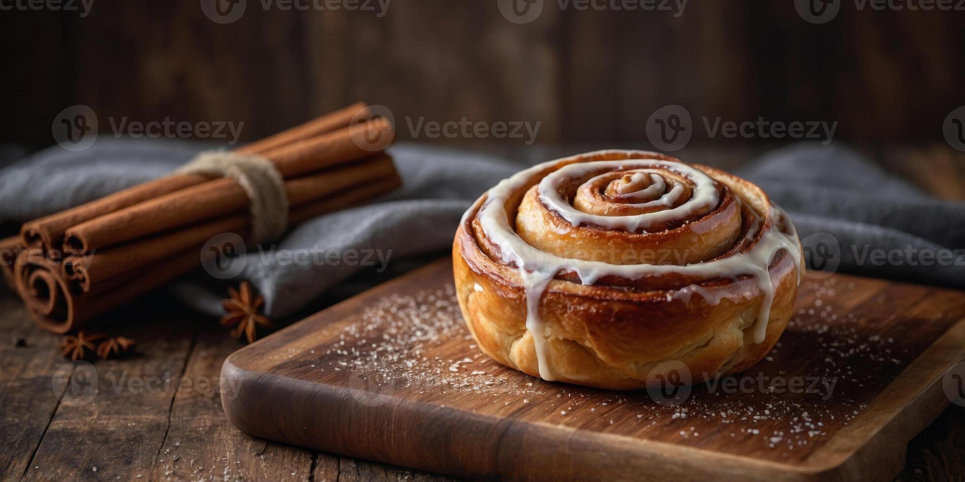 A cinnamon roll sits on a wooden cutting board. photo