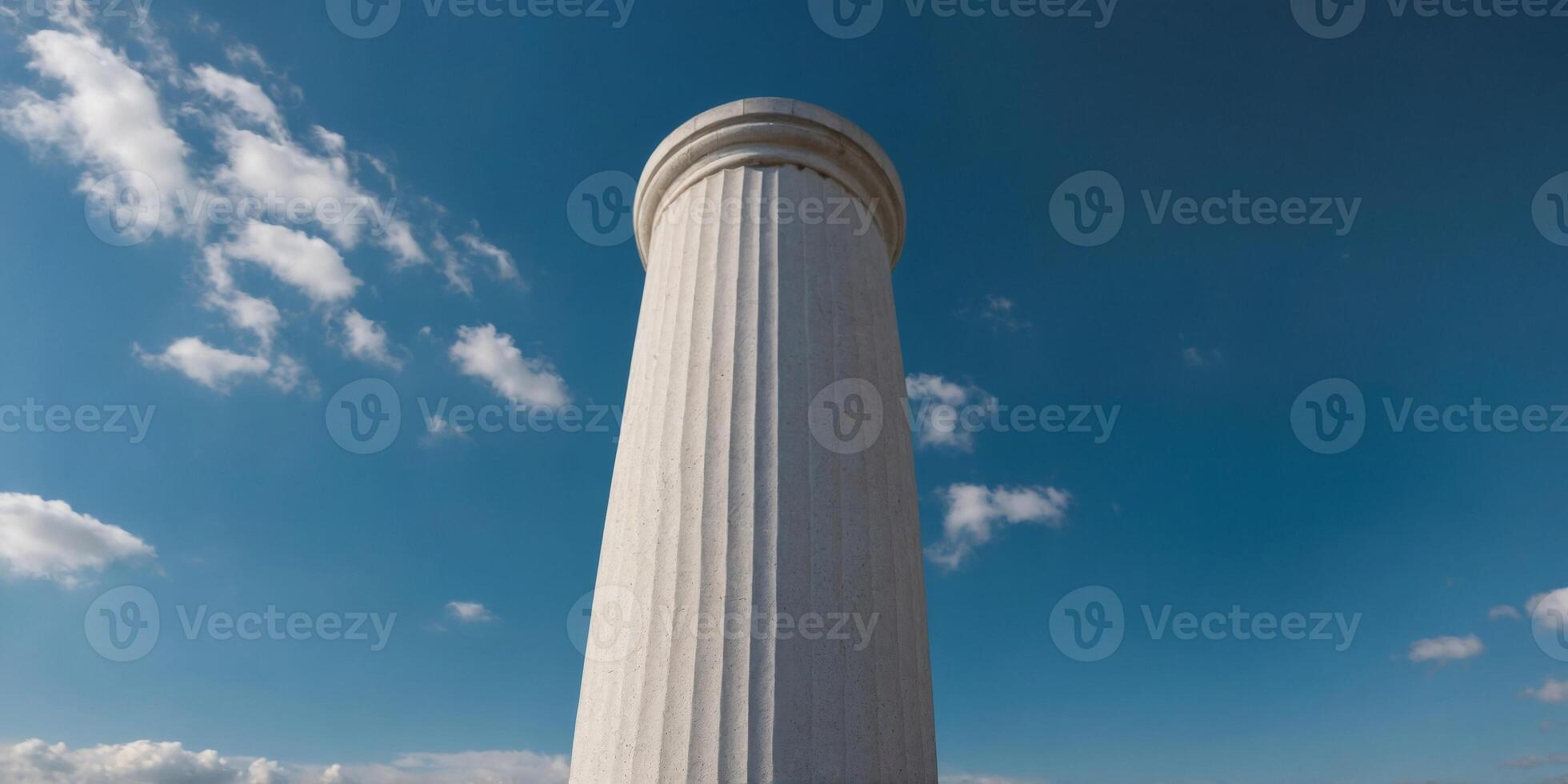 A tall white column with a blue sky in the background. photo