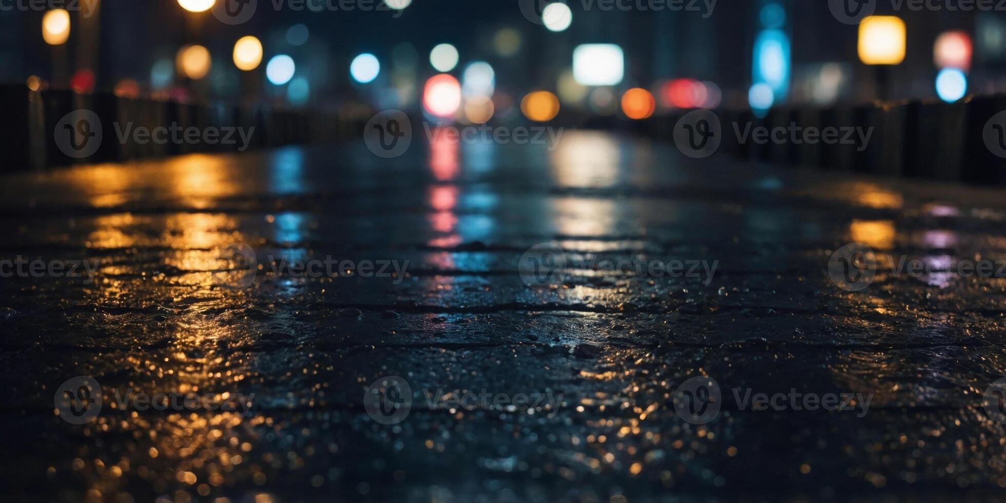 The platform is wet and the city is lit up at night. photo