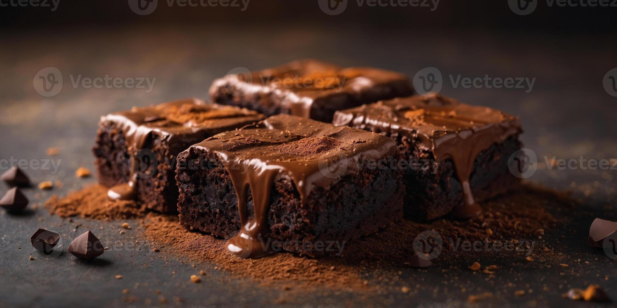Three brownies are on a table with a pile of chocolate powder. photo