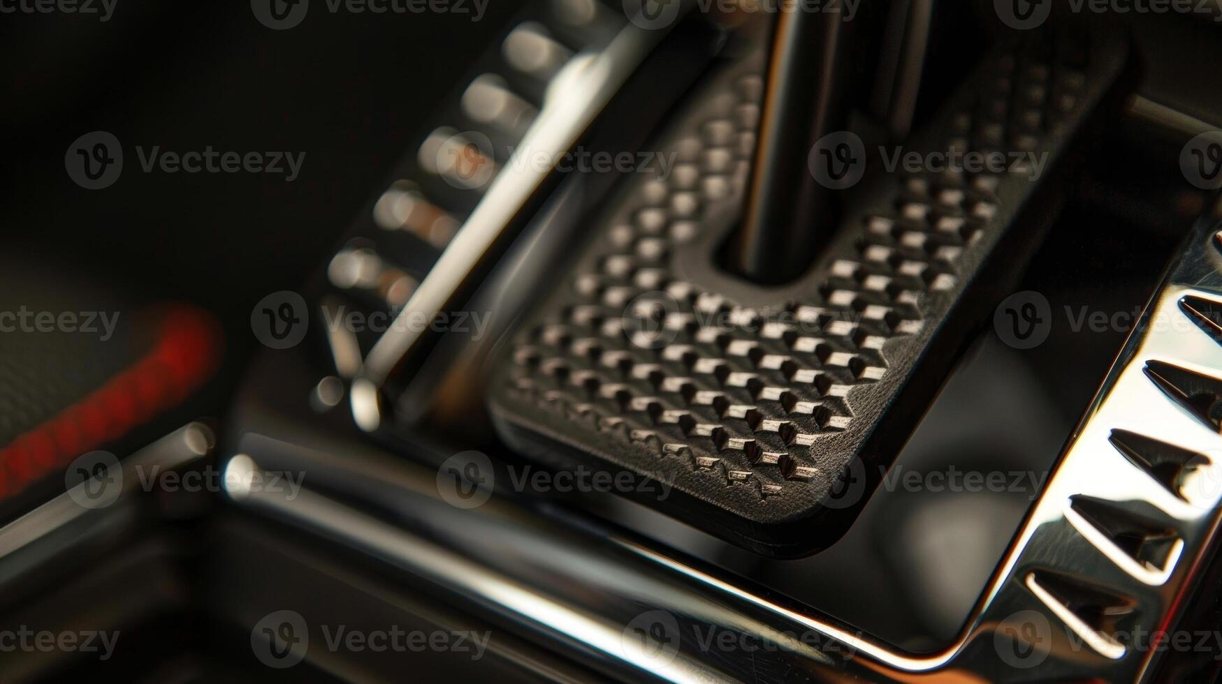A closeup of a footoperated parking brake featuring a textured pedal and directional arrows for engaging and disengaging photo