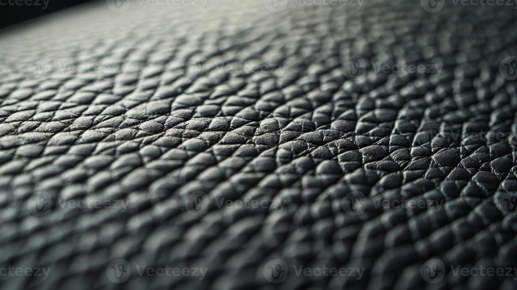 The closeup of a modern interior trim made of black leather with clean lines and a smooth polished surface photo