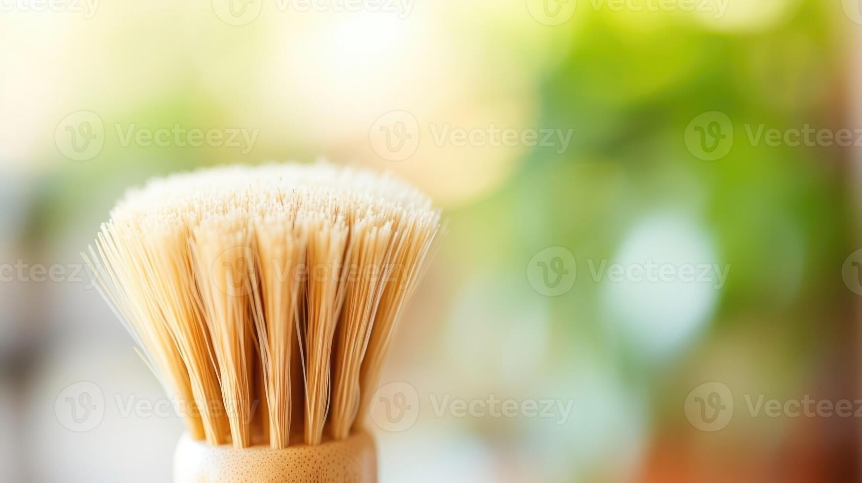 Closeup of an ecofriendly dish brush, featuring a bamboo handle and natural bristles. photo