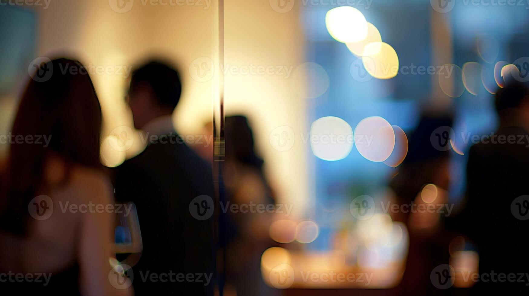 A defocused glimpse of coworkers mingling at an office party showcasing the offices sense of community photo