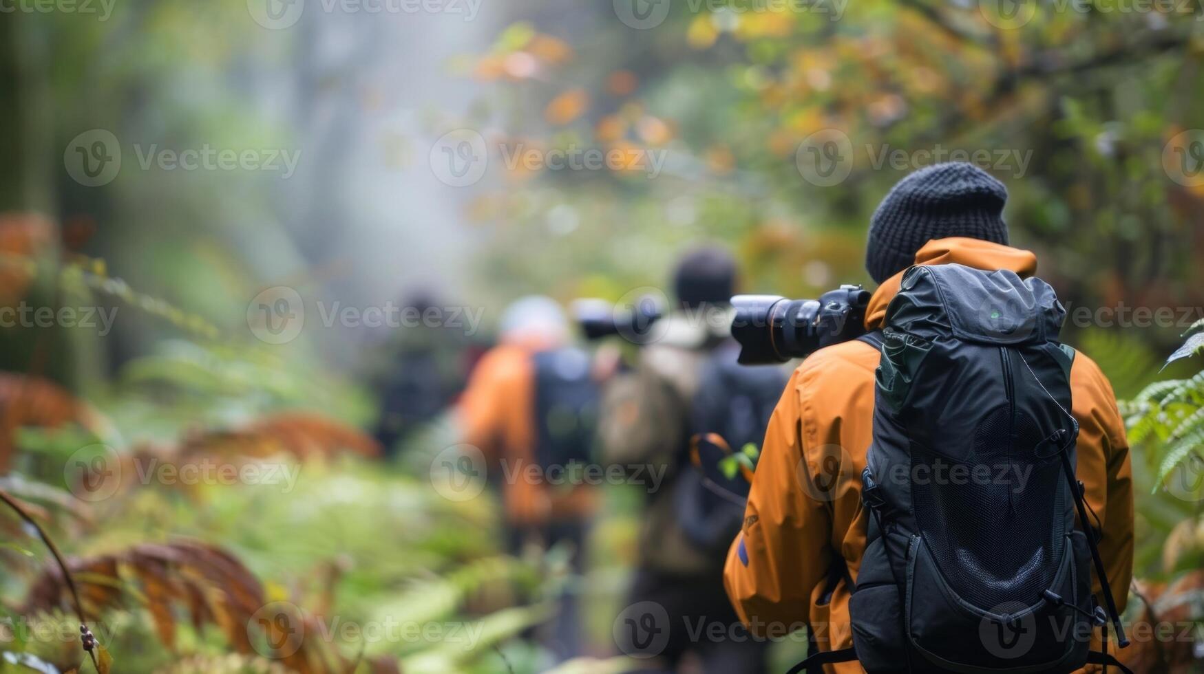 Blurry shot of a group of photographers trekking through a dense forest determined to capture the elusive wildlife within photo