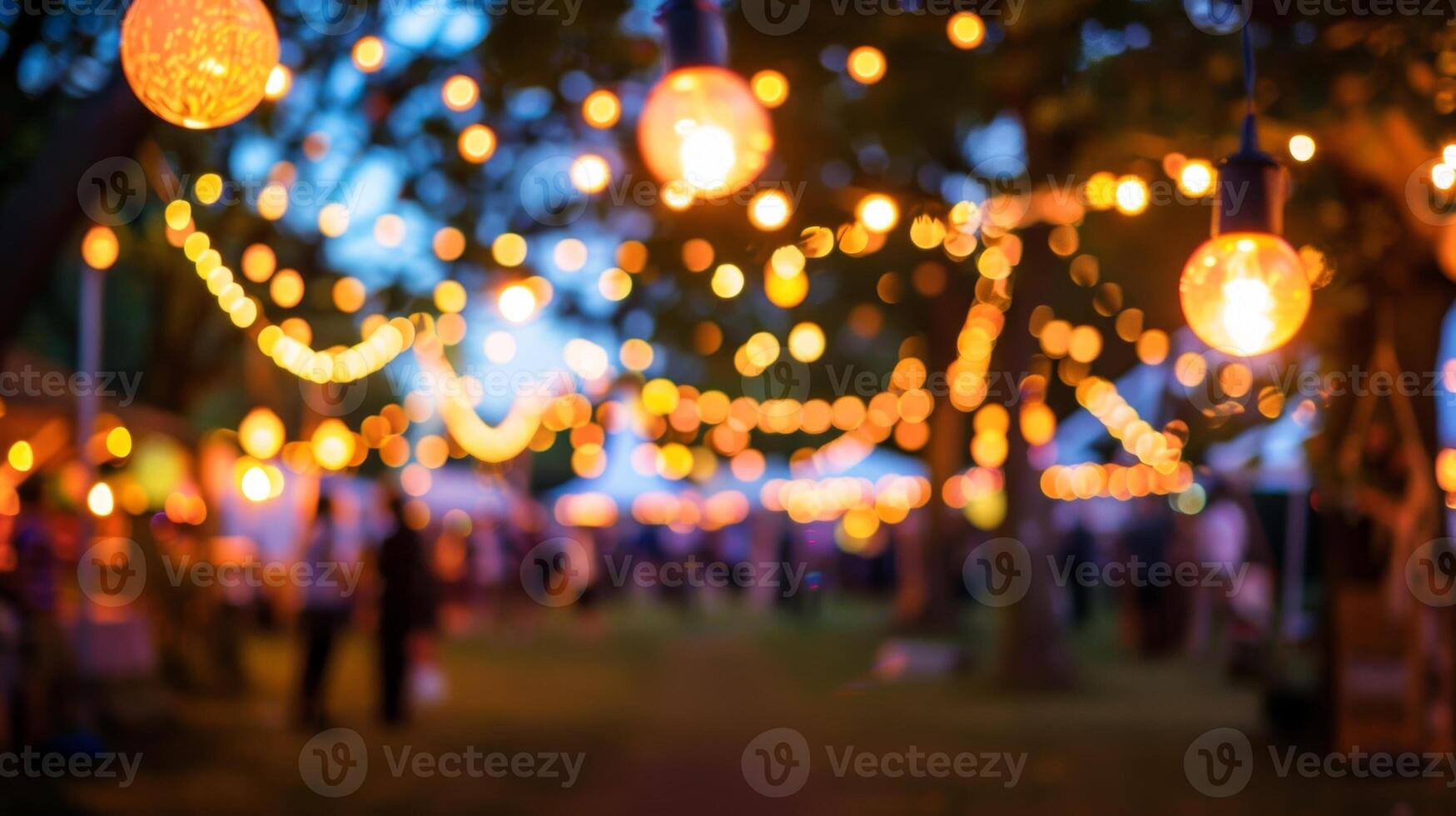 A defocused view of the festival at dusk with ling fairy lights guiding the way photo