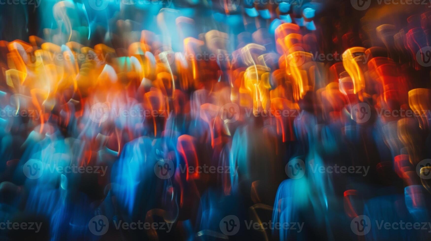 The defocused audience creates an abstract painting in front of the stage photo