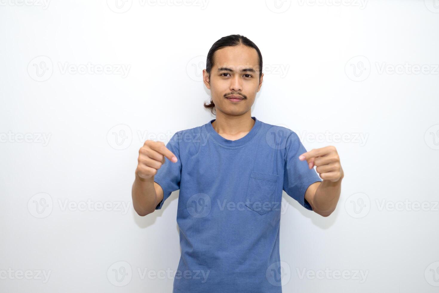 Asian man smiling with both hands pointing down. isolated on white background photo