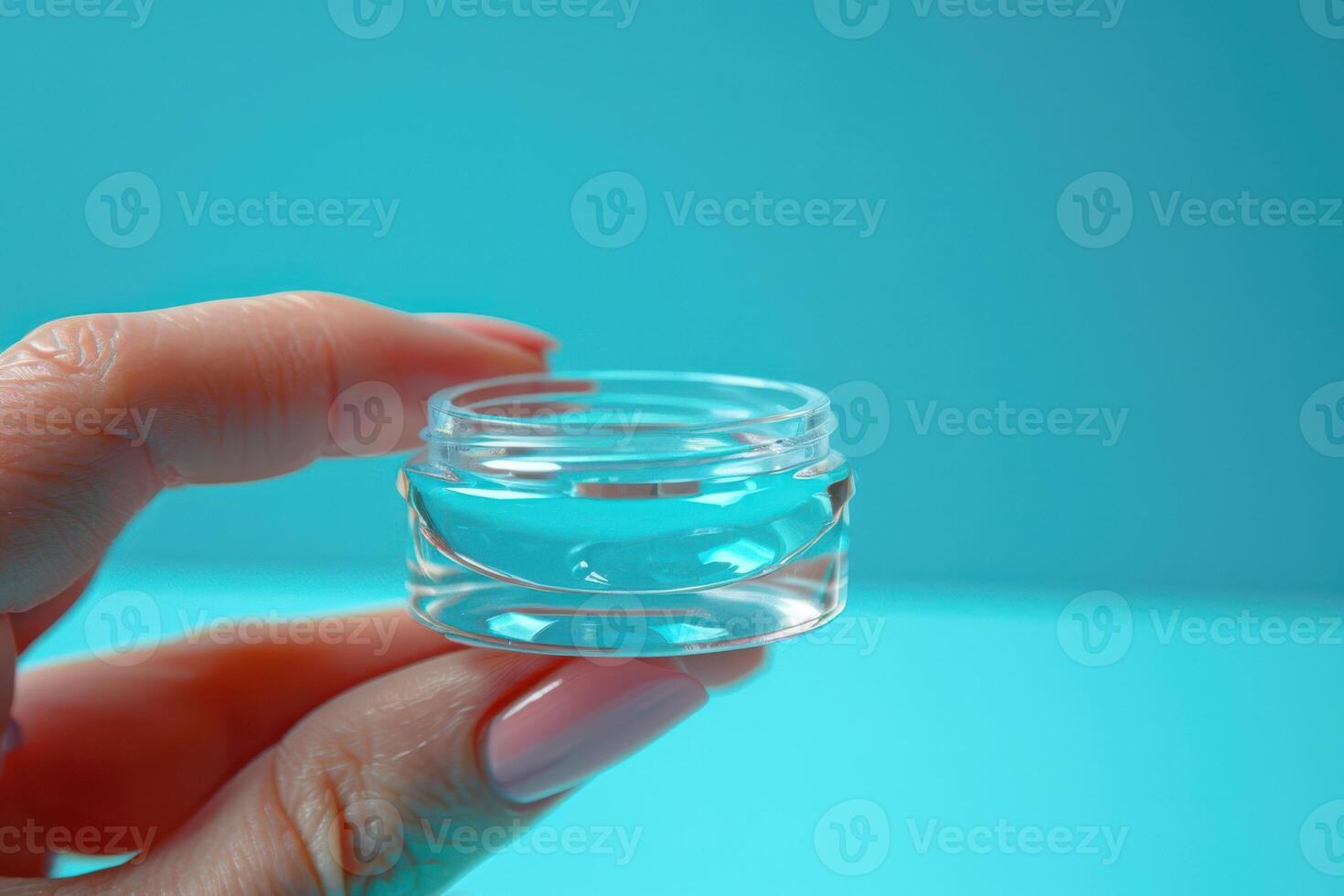 Contact Lens Liquid with Lens Container in Hand photo