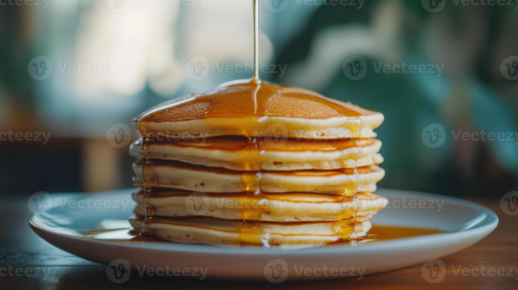 Stack of Pancakes with Maple Syrup on a Plate photo
