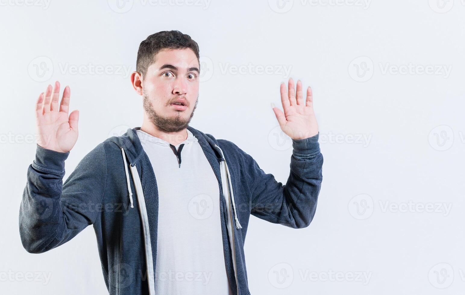 Scared man with raised hands isolated. Person with scared face with raised hands photo