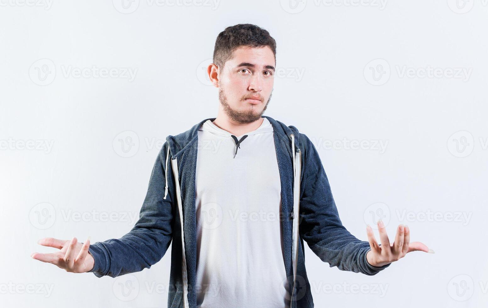 Puzzled person spreading hands isolated. Clueless young man with open arms photo