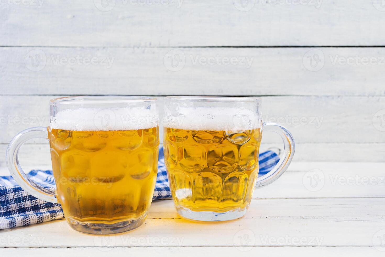 Oktoberfest background. Beer mug and Bavarian symbolic fabric photo