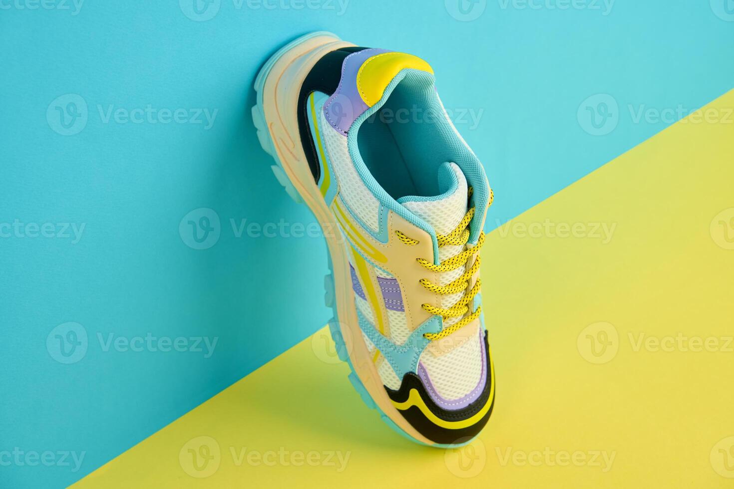 White sneaker with colored accents on bright background, Fashionable sport shoe with colorful backdrop. Studio shot of shoes for shop advertisement, creative minimalist style photo