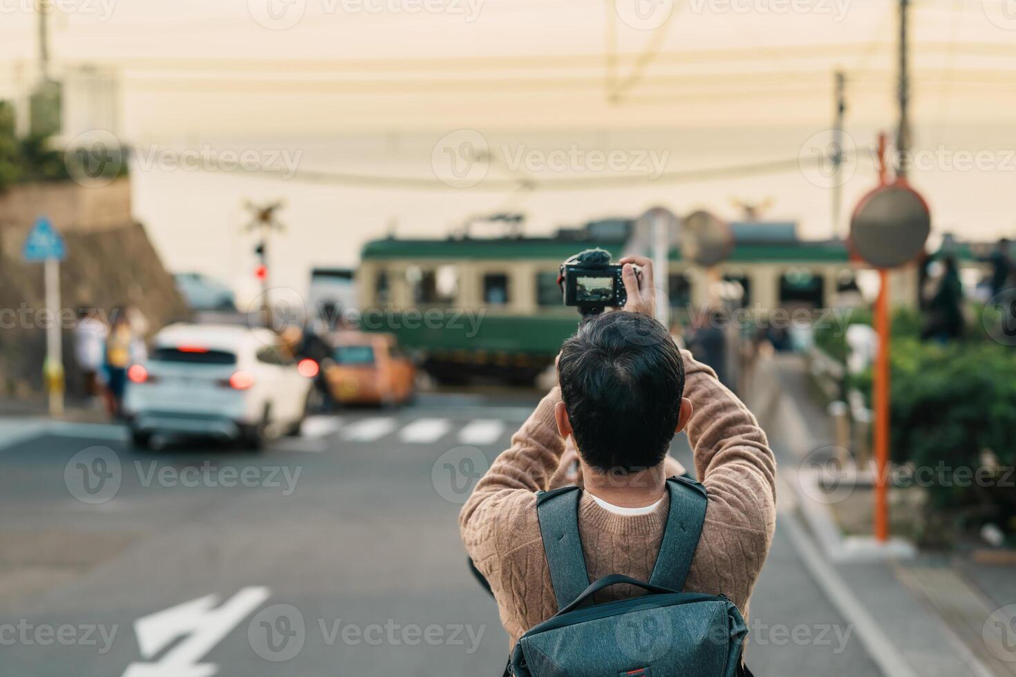 man tourist Visiting in Kamakura, Kanagawa, Japan. happy Traveler sightseeing Kamakurakokomae train station. Landmark and popular for tourists attraction near Tokyo. Travel and Vacation concept photo
