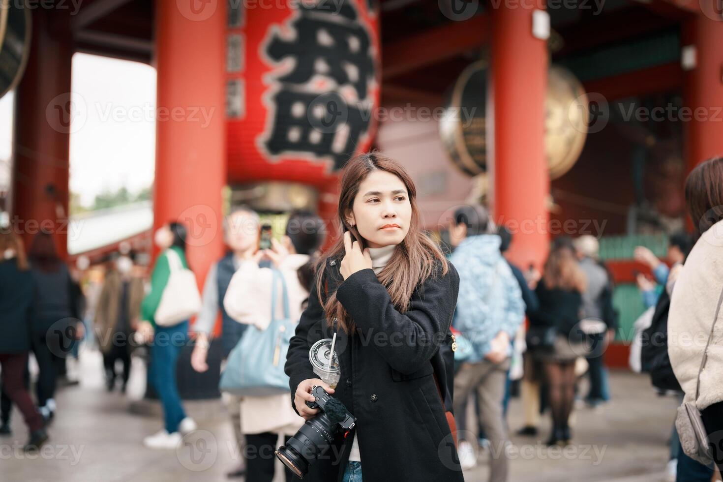 Tourist woman visit Sensoji Temple or Asakusa Kannon Temple is a Buddhist temple located in Asakusa, Tokyo Japan. Japanese sentence on red lantern means Thunder gate. photo
