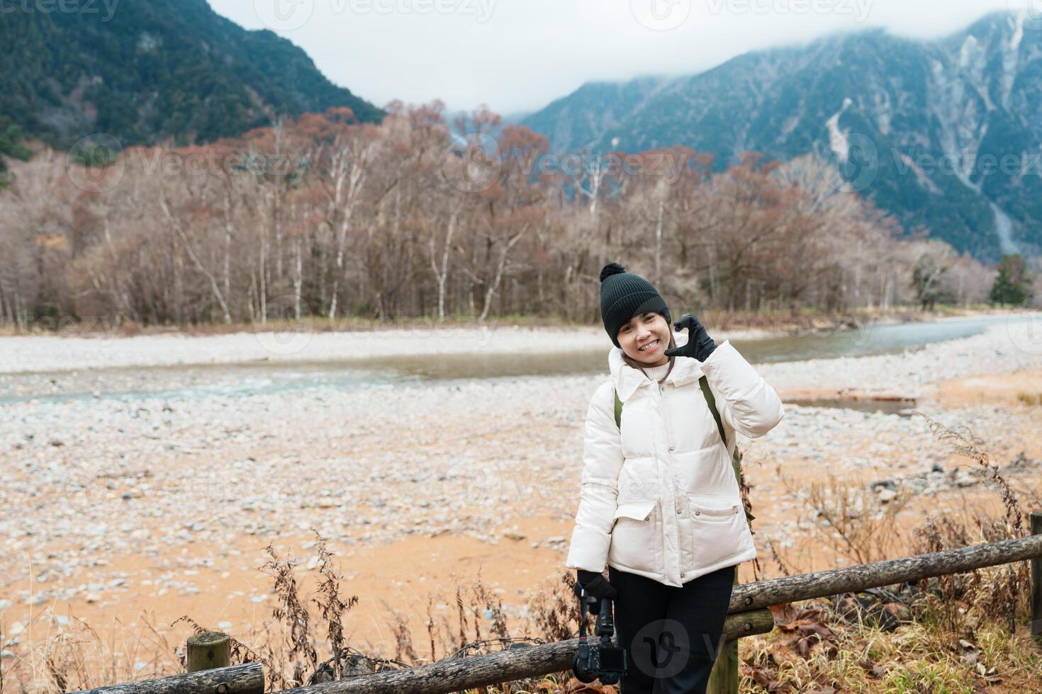 Woman tourist travel Kamikochi National Park, happy Traveler sightseeing Azusa river with mountain, Nagano Prefecture, Japan. Landmark for tourists attraction. Japan Travel, Destination and Vacation photo