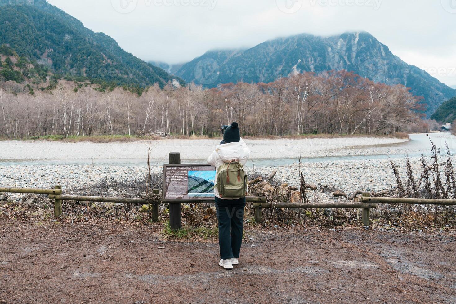 Woman tourist travel Kamikochi National Park, happy Traveler sightseeing Azusa river with mountain, Nagano Prefecture, Japan. Landmark for tourists attraction. Japan Travel, Destination and Vacation photo