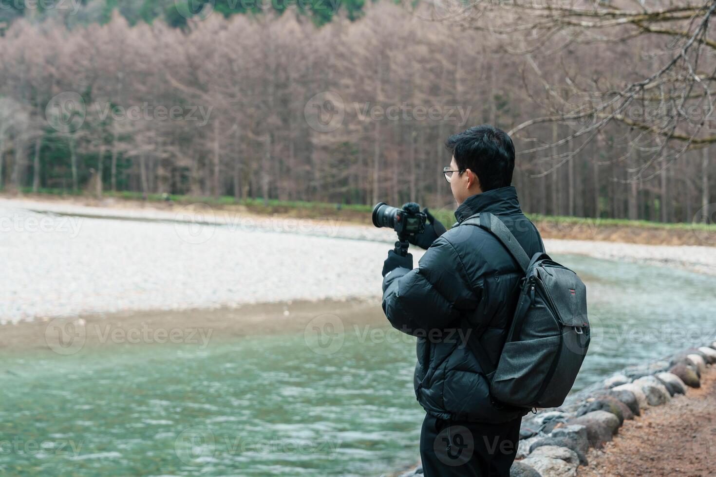 man tourist travel Kamikochi National Park, happy Traveler sightseeing Azusa river with mountain, Nagano Prefecture, Japan. Landmark for tourists attraction. Japan Travel, Destination and Vacation photo
