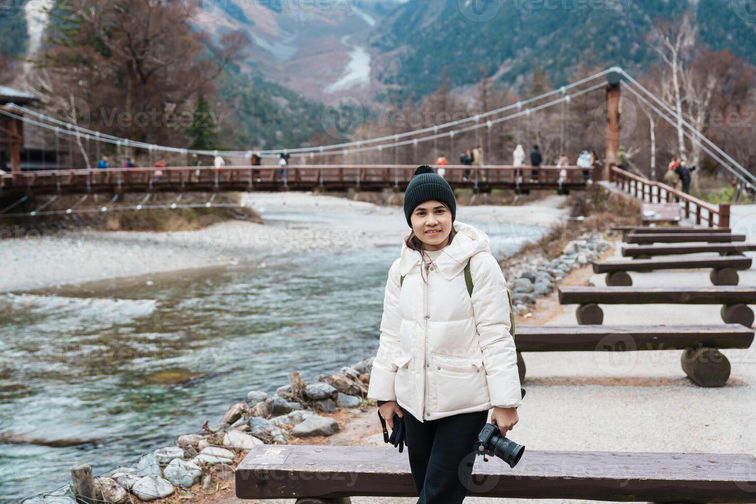 Woman tourist travel Kamikochi National Park, happy Traveler sightseeing Kappa bashi bridge, Nagano Prefecture, Japan. Landmark for tourists attraction. Japan Travel, Destination and Vacation concept photo