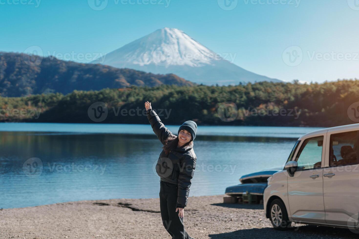 Woman tourist enjoy with Fuji Mountain at Lake Saiko, happy Traveler sightseeing Mount Fuji and road trip Fuji Five Lakes. Landmark for tourists attraction. Japan Travel, Destination and Vacation photo