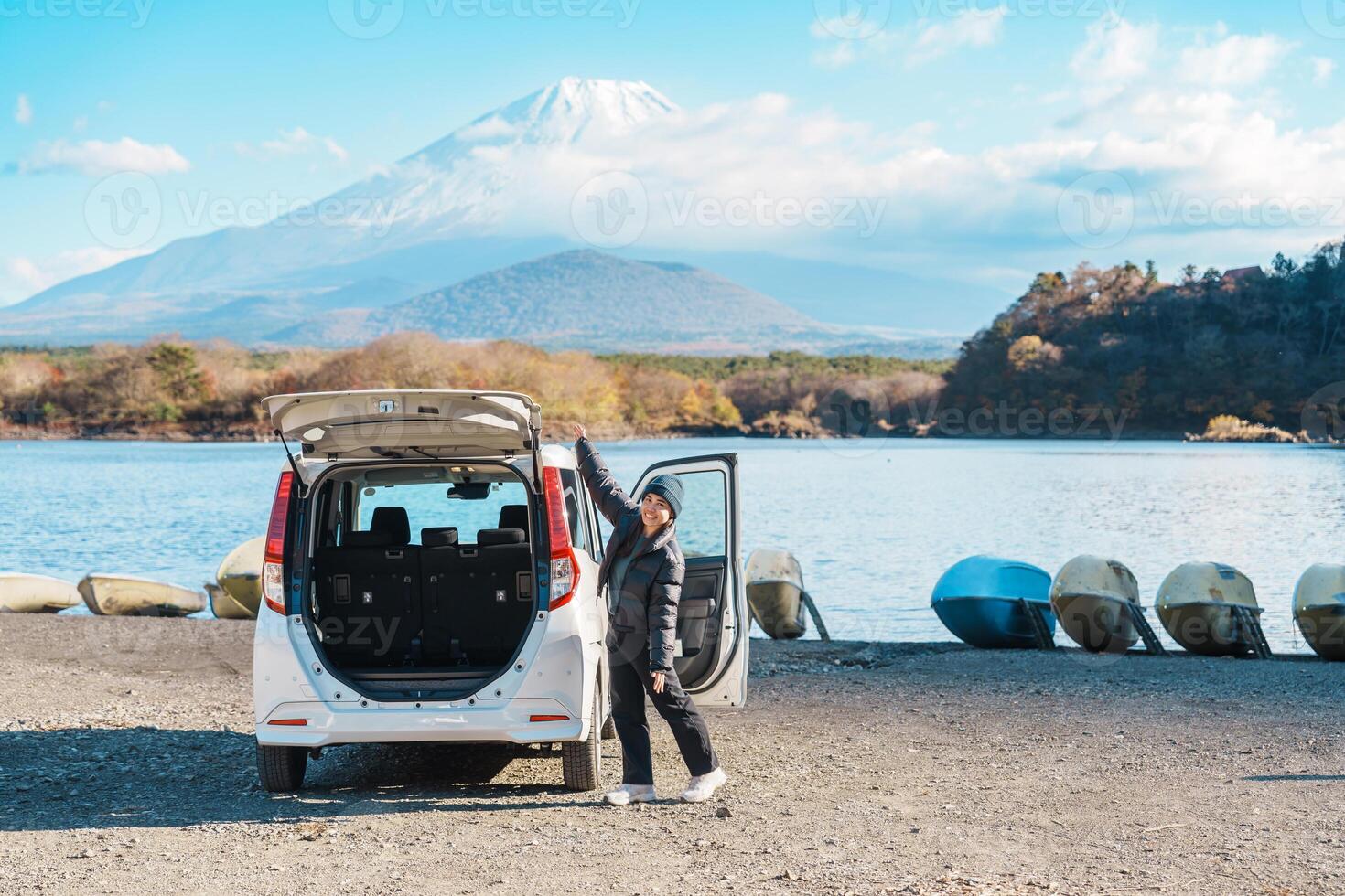 Woman tourist enjoy with Fuji Mountain at Lake Shoji, happy Traveler sightseeing Mount Fuji and road trip Fuji Five Lakes. Landmark for tourists attraction. Japan Travel, Destination and Vacation photo