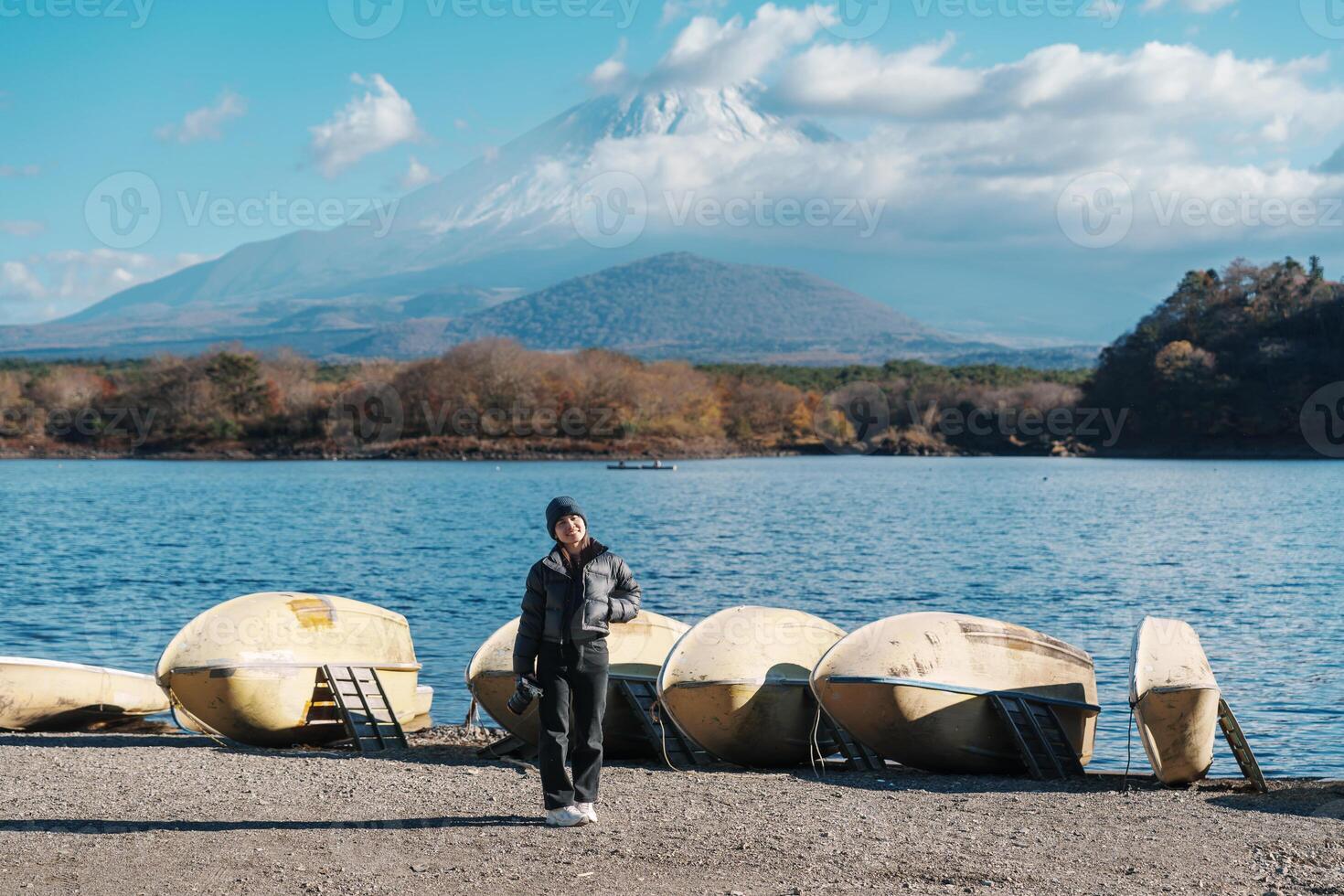Woman tourist enjoy with Fuji Mountain at Lake Shoji, happy Traveler sightseeing Mount Fuji and road trip Fuji Five Lakes. Landmark for tourists attraction. Japan Travel, Destination and Vacation photo