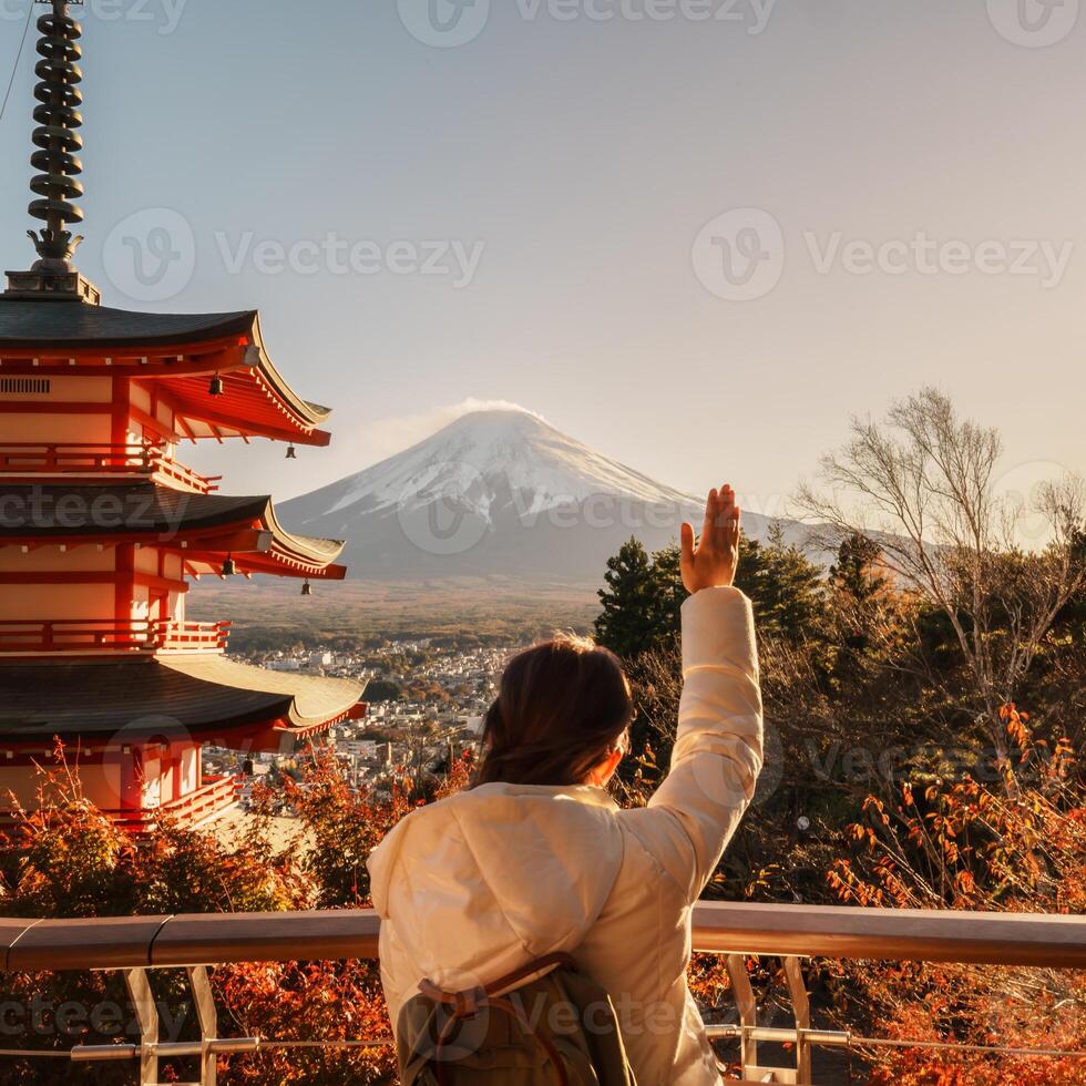 Woman tourist with mount Fuji at Chureito Pagoda in Autumn season, Traveler travel Arakurayama Sengen Park, Yamanashi, Japan. Landmark for tourist attraction. Japan Travel, Destination and Vacation photo