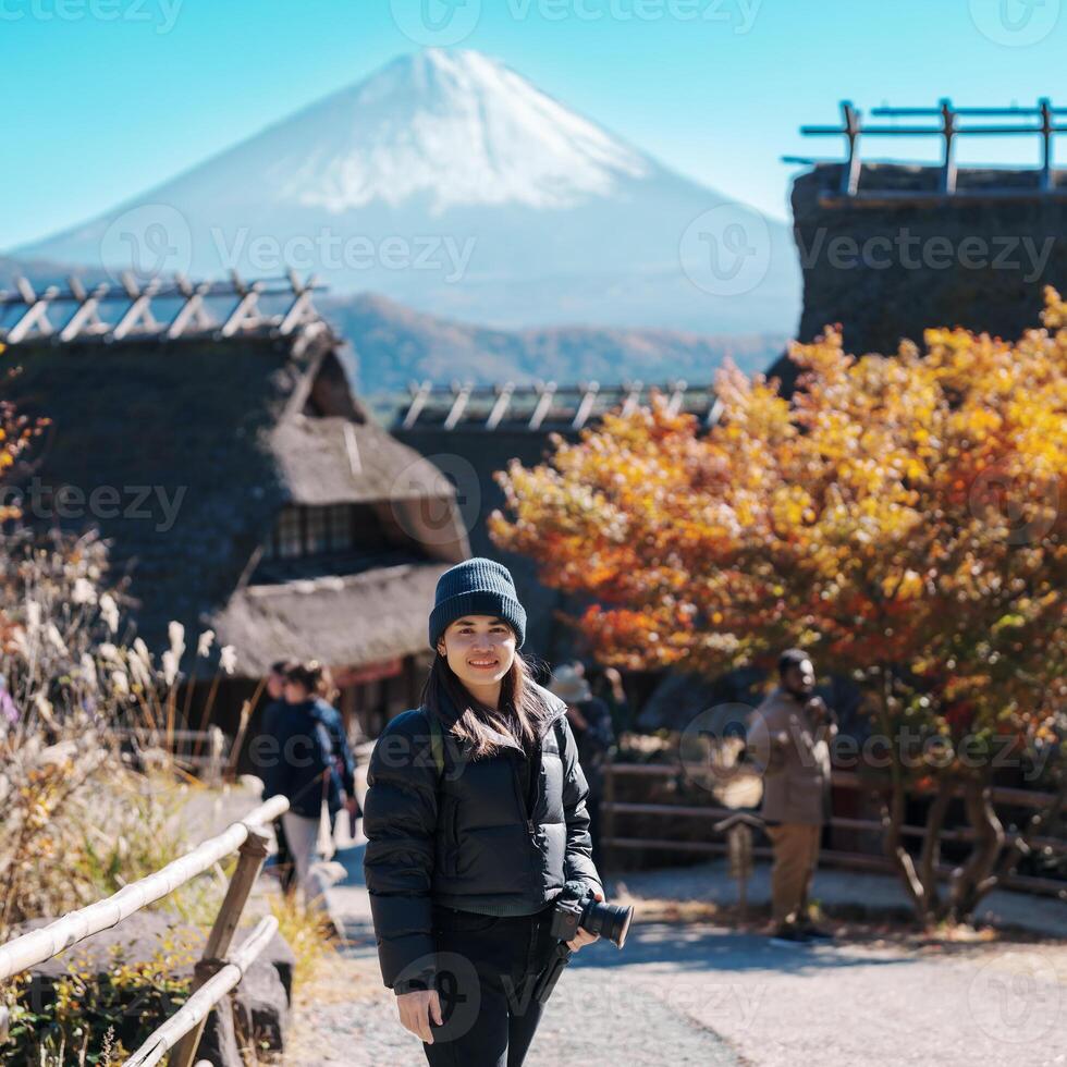Woman tourist with mount Fuji at Saiko Iyashino Sato Nenba in Autumn season, happy Traveler travel Mt Fuji, Yamanashi, Japan. Landmark for tourist attraction. Japan Travel, Destination and Vacation photo