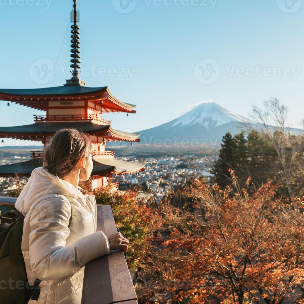 Woman tourist with mount Fuji at Chureito Pagoda in Autumn season, Traveler travel Arakurayama Sengen Park, Yamanashi, Japan. Landmark for tourist attraction. Japan Travel, Destination and Vacation photo