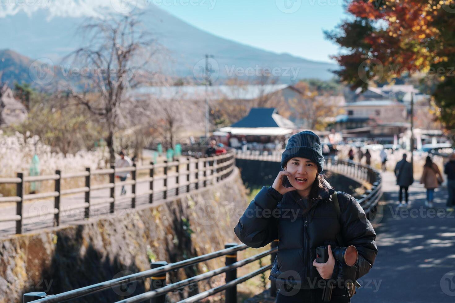 Woman tourist with mount Fuji at Saiko Iyashino Sato Nenba in Autumn season, happy Traveler travel Mt Fuji, Yamanashi, Japan. Landmark for tourist attraction. Japan Travel, Destination and Vacation photo