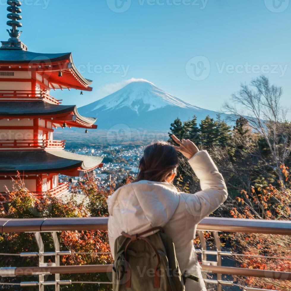 Woman tourist with mount Fuji at Chureito Pagoda in Autumn season, Traveler travel Arakurayama Sengen Park, Yamanashi, Japan. Landmark for tourist attraction. Japan Travel, Destination and Vacation photo