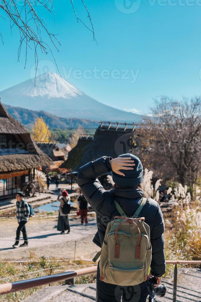 Woman tourist with mount Fuji at Saiko Iyashino Sato Nenba in Autumn season, happy Traveler travel Mt Fuji, Yamanashi, Japan. Landmark for tourist attraction. Japan Travel, Destination and Vacation photo