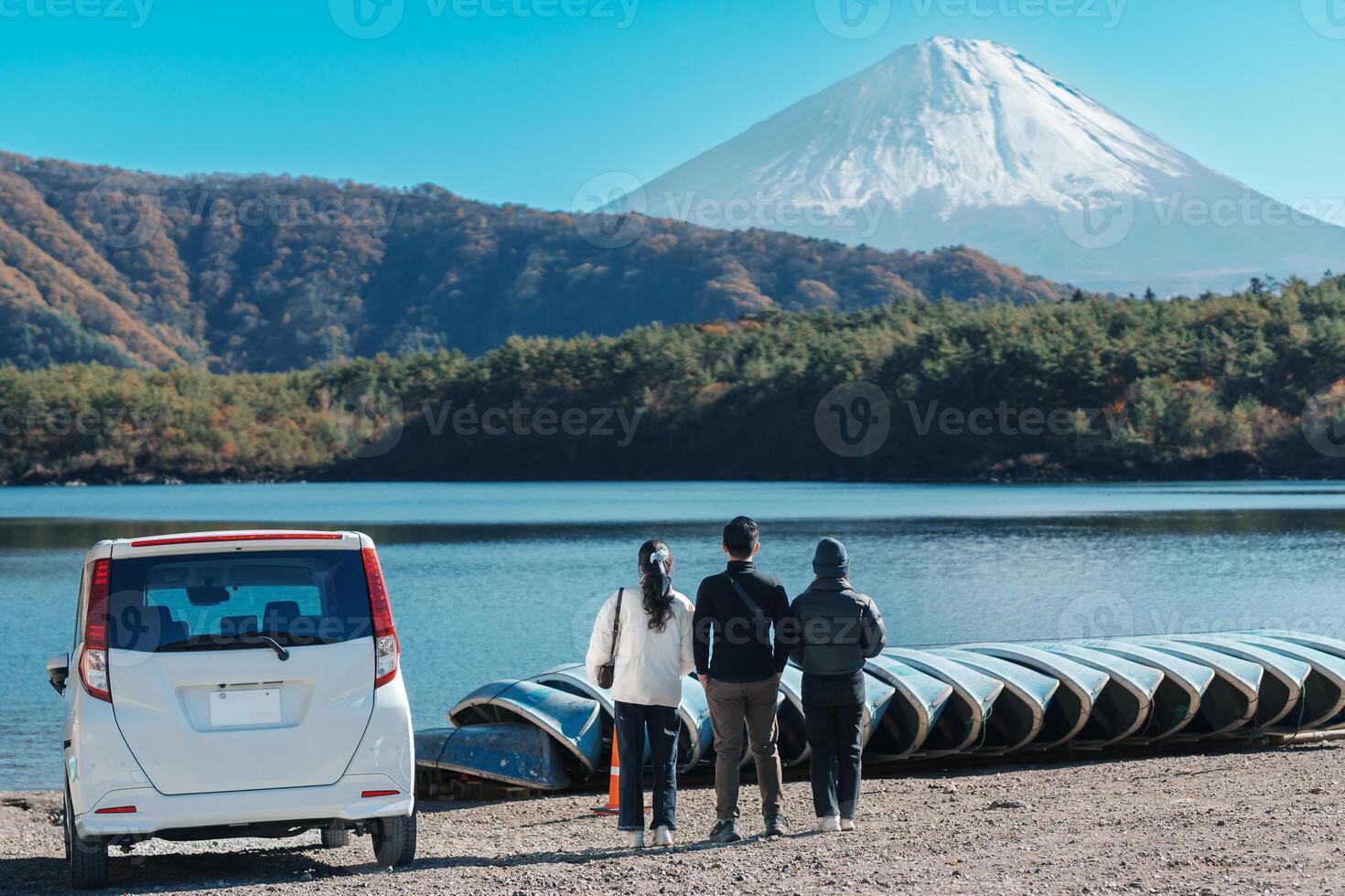 tourists enjoy with Fuji Mountain at Lake Saiko, happy friends group travel Mount Fuji and road trip Fuji Five Lakes. Landmark for tourists attraction. Japan Travel, Destination and Vacation concept photo