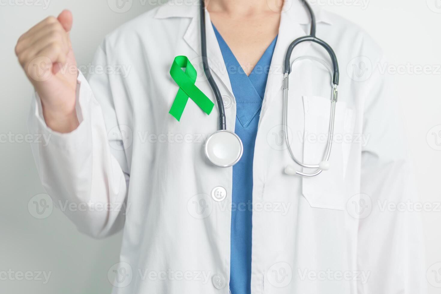 Doctor with green Ribbon for world Lymphoma Awareness September month, world Mental Health Day, Liver, Gallbladders, bile duct, cervical, kidney Cancer. Healthcare and world cancer day concept photo