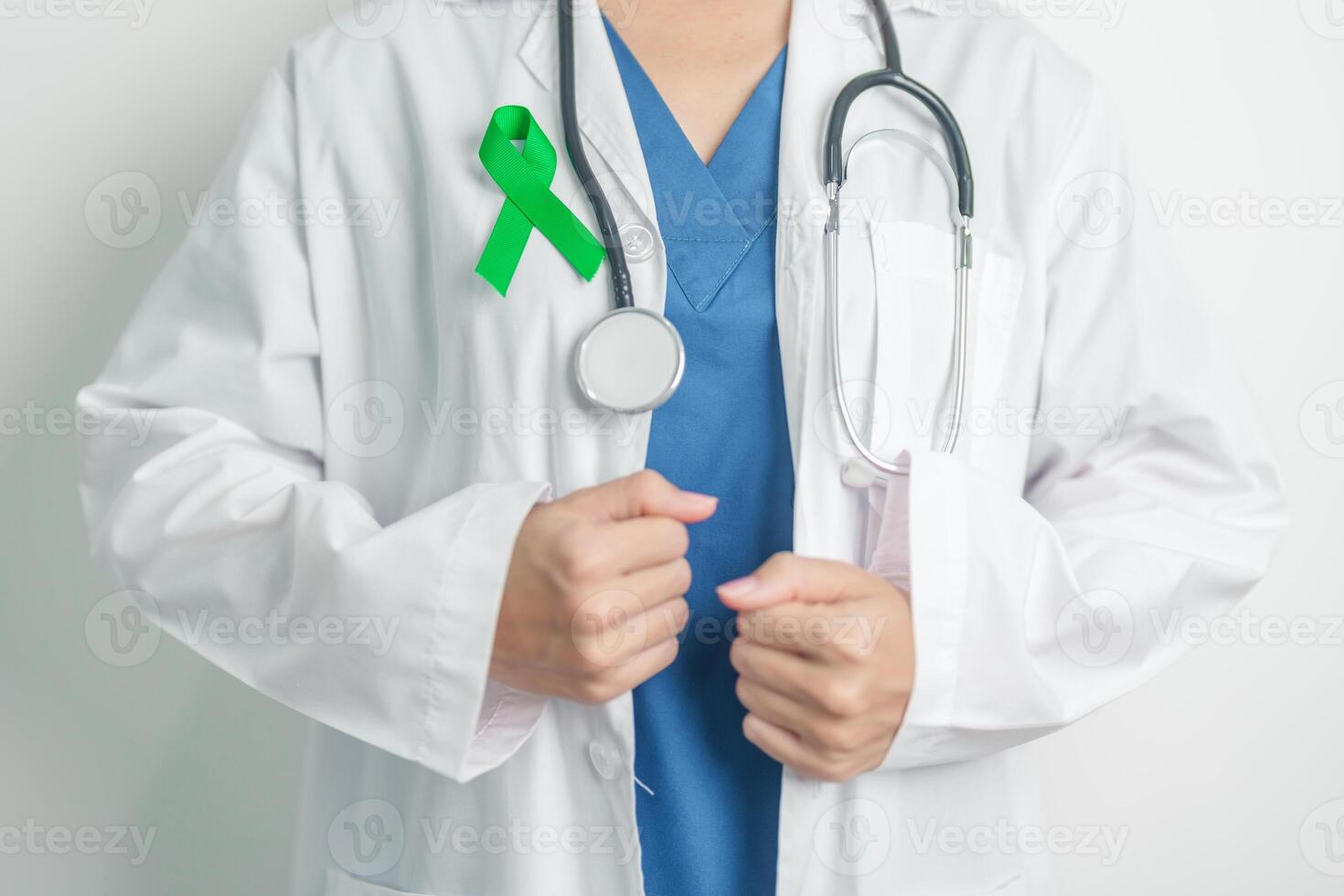 Doctor with green Ribbon for world Lymphoma Awareness September month, world Mental Health Day, Liver, Gallbladders, bile duct, cervical, kidney Cancer. Healthcare and world cancer day concept photo