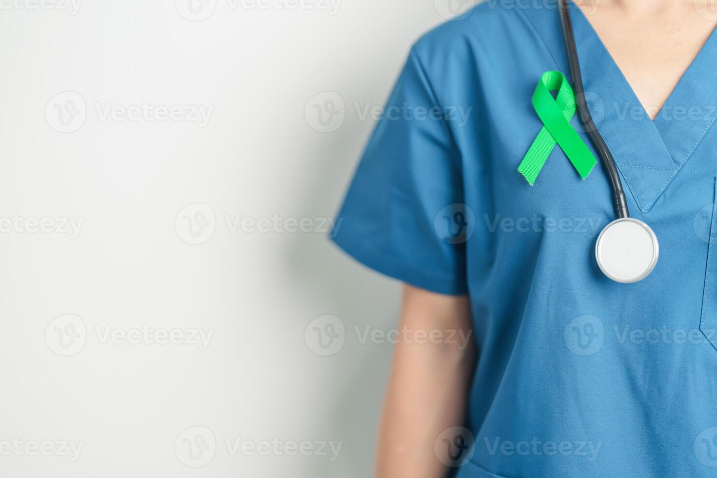Doctor with green Ribbon for world Lymphoma Awareness September month, world Mental Health Day, Liver, Gallbladders, bile duct, cervical, kidney Cancer. Healthcare and world cancer day concept photo