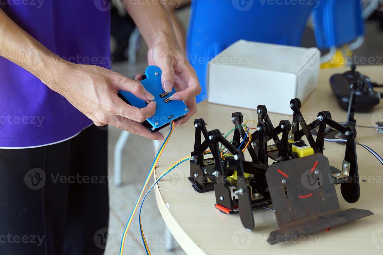 Asian high school students practice moving robots on the playing field To perform missions according to the rules of the robot competition. Soft and selective focus. photo