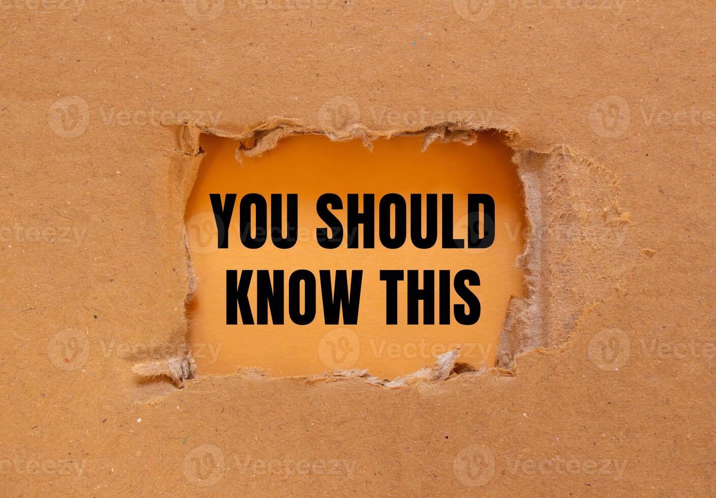 You should know this message written on ripped torn cardboard paper with orange background. Conceptual you should know this symbol. Copy space. photo