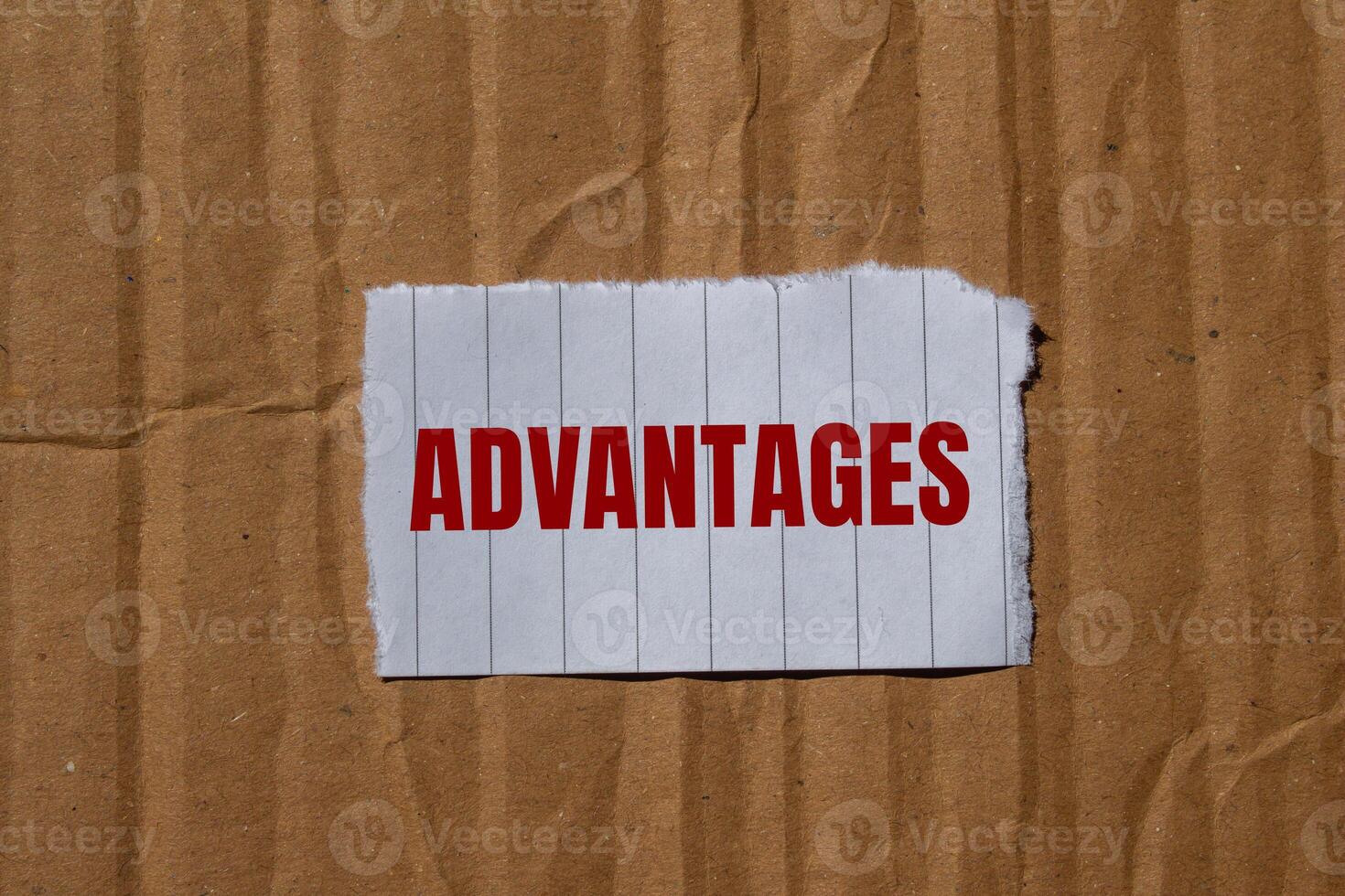 Advantages message written on ripped torn paper with cardboard background. Conceptual advantages symbol. Copy space. photo