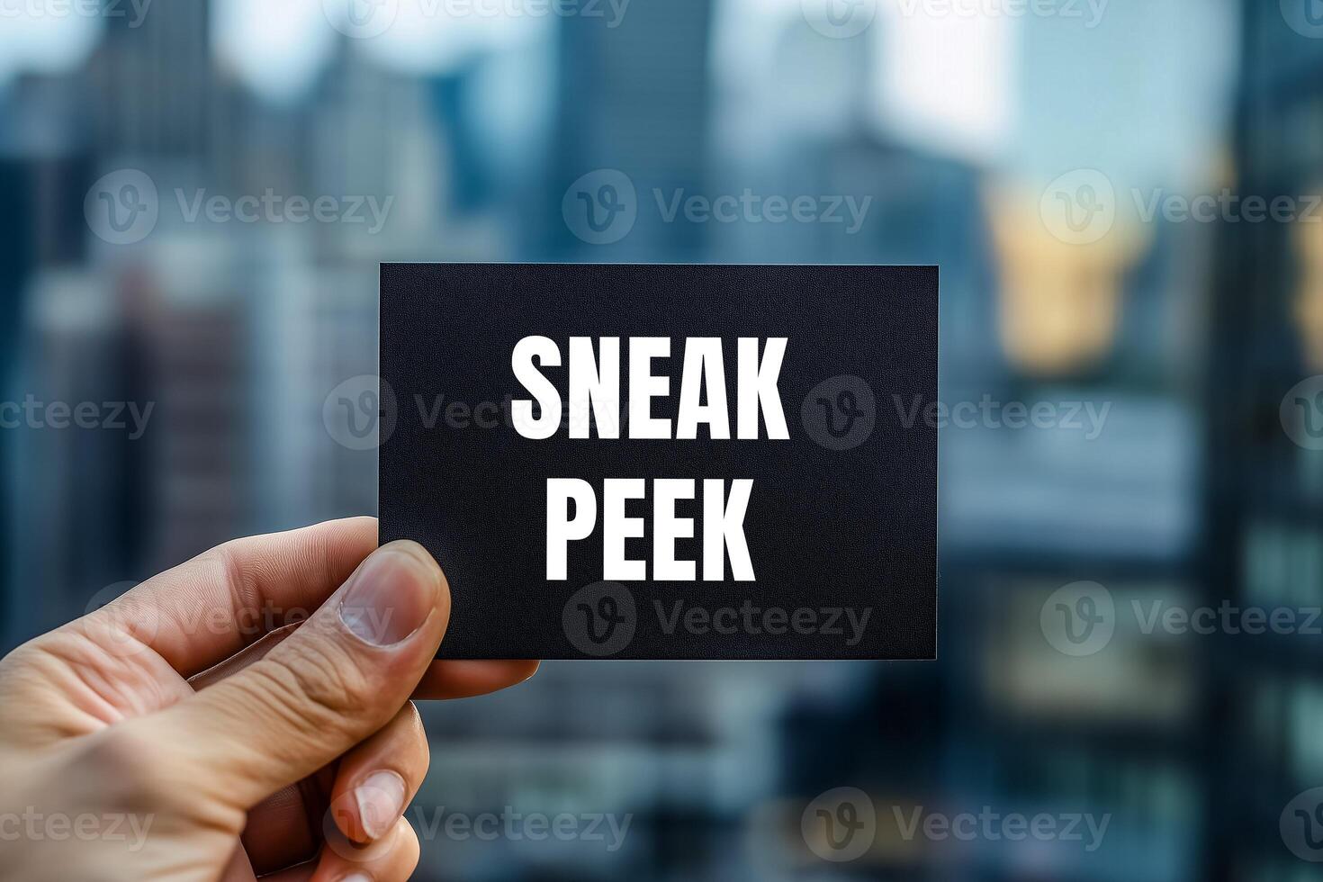 Sneak peek message written on black card with blurry modern city background. Conceptual sneak peek symbol. Copy space. photo