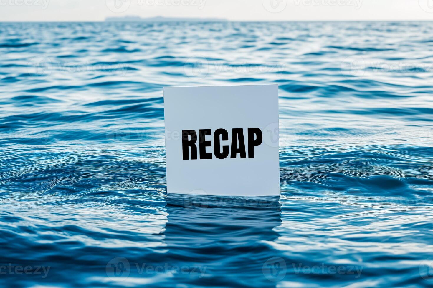 Recap word written on a white card on sea. Conceptual recap word symbol. photo