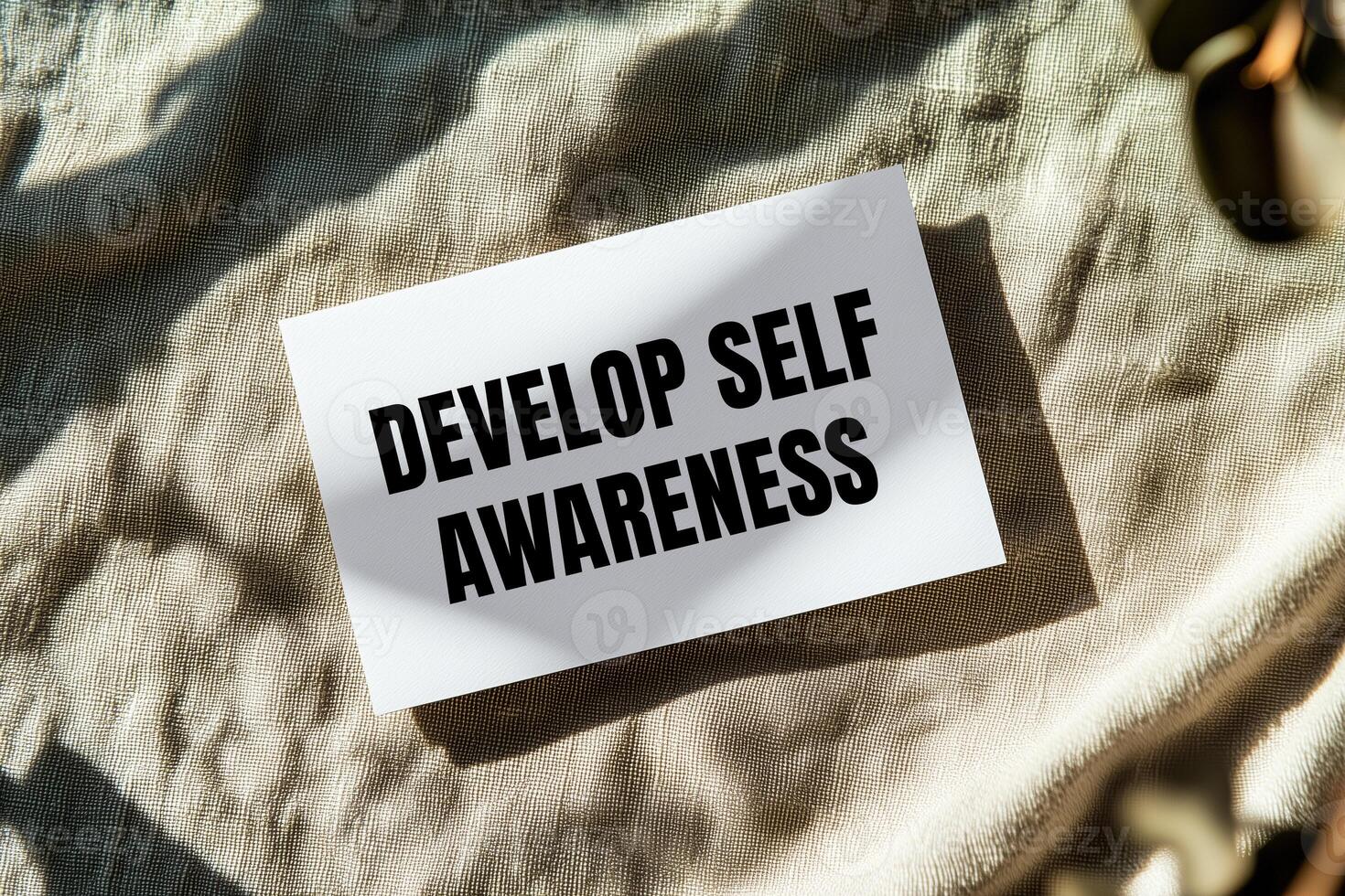 Develop self awareness message written on white paper with fabric background. Conceptual develop self awareness symbol. Copy space. photo