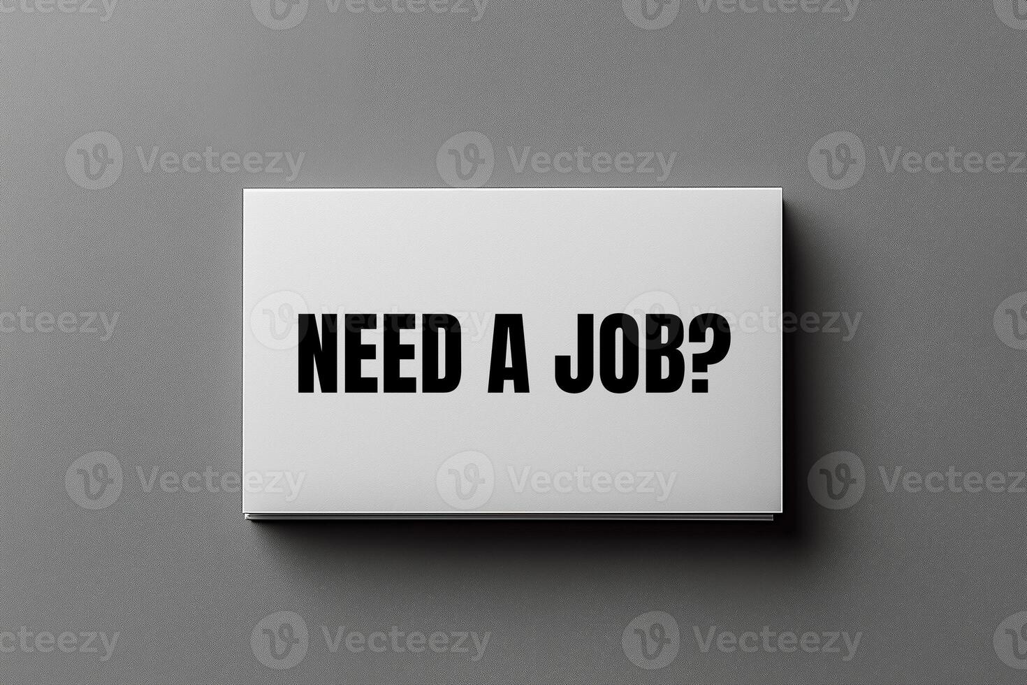 Need a job message written on business card on grey background. Conceptual need a job question symbol. Copy space. photo