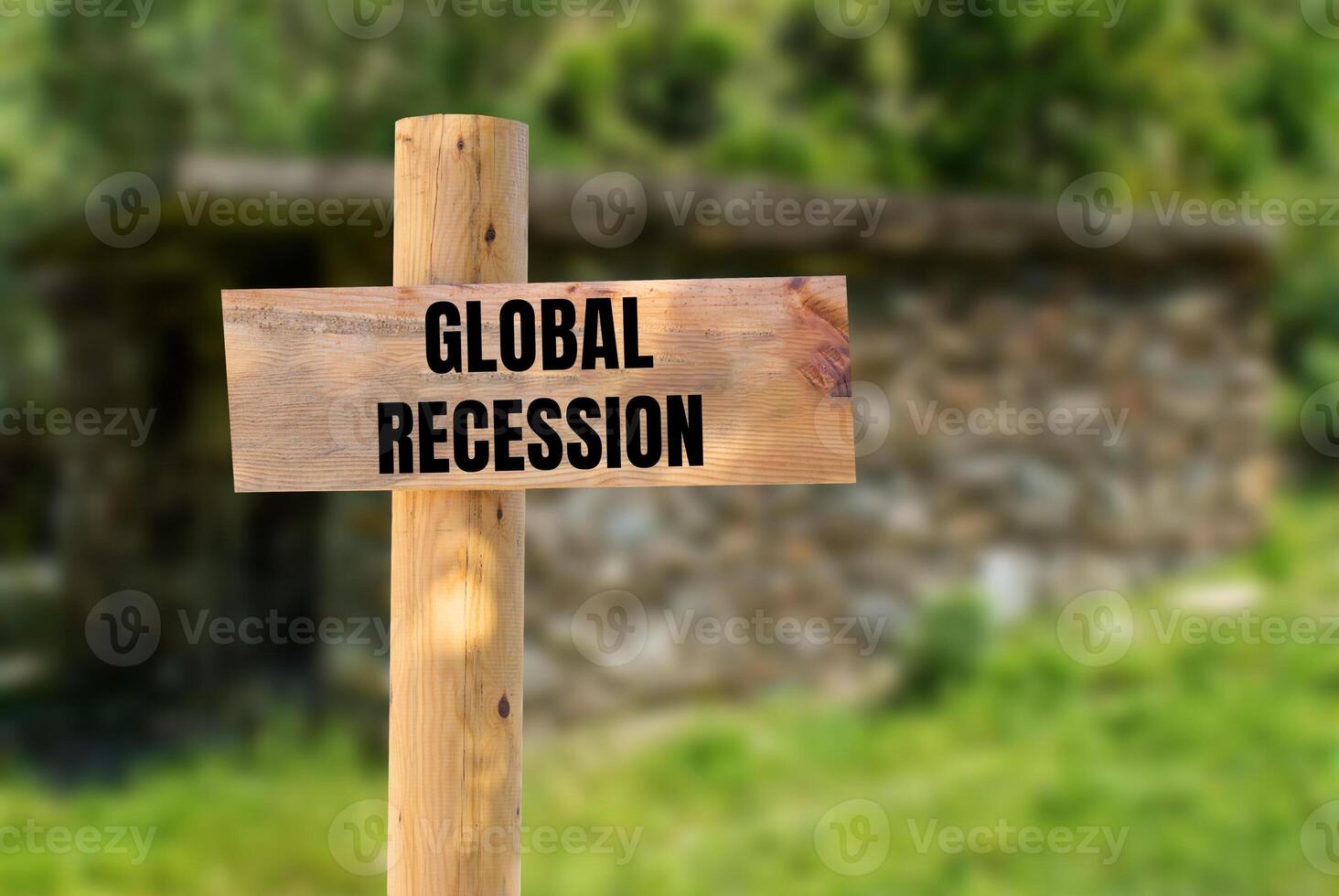 Global recession message written on wooden sign with nature background. Conceptual global recession symbol. Copy space. photo